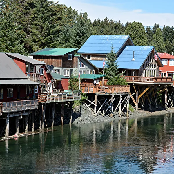 Row of colorful houses perched above the water on stilts