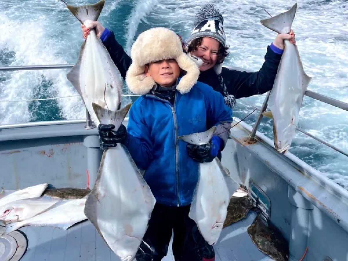 a person holding a fish on a boat in the water
