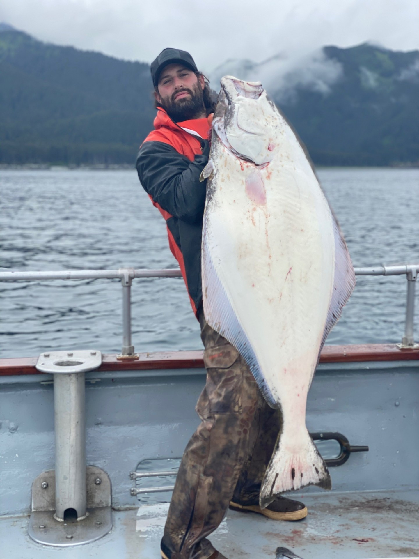 a man holding a fish in the water